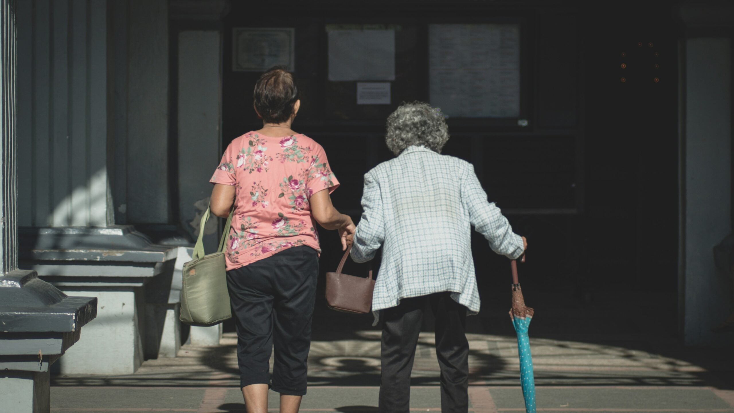 Aging parent and adult daughter talking together at home about staying independent